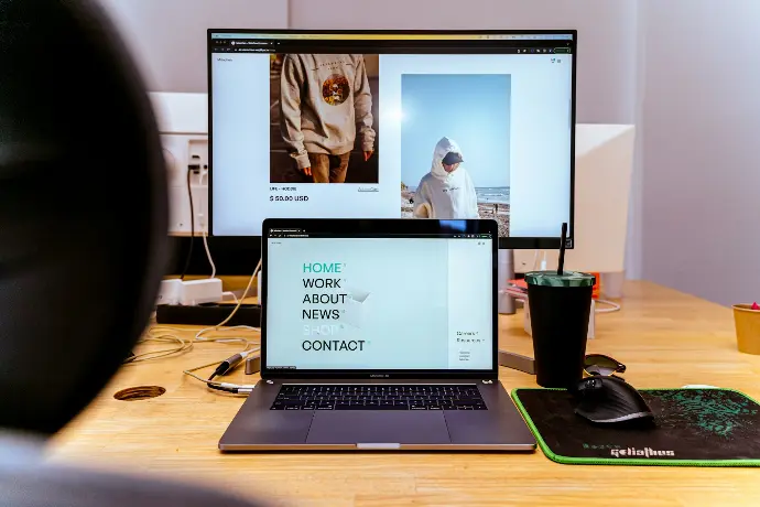 a laptop computer sitting on top of a wooden desk